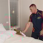 Technician treating a mattress with Electrodry’s Healthy Mattress Solution.