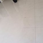 Before and after tile cleaning and grout re-colouring of floors.