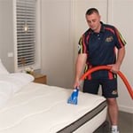 Technician performing a Deluxe Mattress Clean.